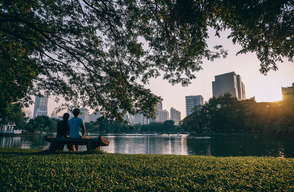 two people sitting on a bench in bangkok