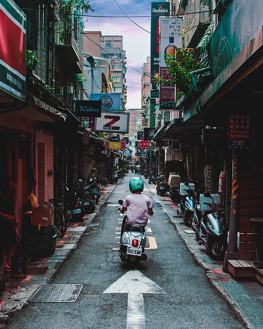 Moped riding through narrow street
