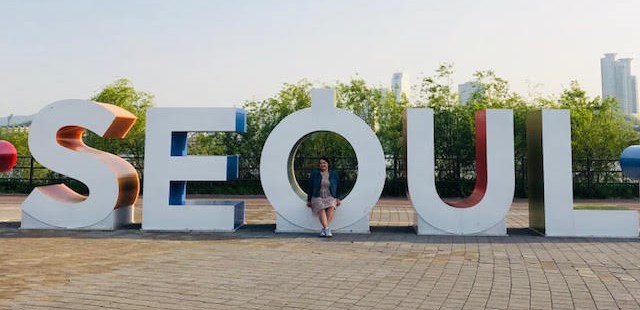 UNI student in front of Seoul sign