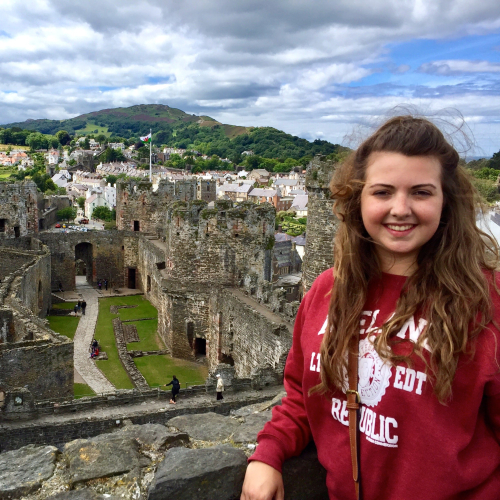 student in front of castle 